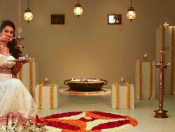 Young woman burning oil lamp with her daughter Stock Footage