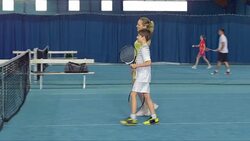 DS LS Family Playing Indoor Tennis Stock Footage