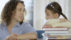 Mother helping daughter with homework Stock Footage