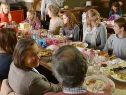 MS TU Shot of Festive lunch in pub with Three generations of family, Granddad and Two grandmas and Two dads and Two mums and Three girls and a boy / London, England, United Kingdom Stock Footage