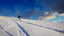 SLO MO Woman having fun skiing down ski slope Stock Footage