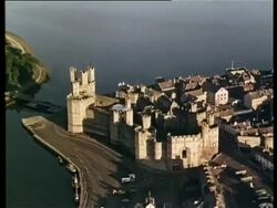 Aerial view of Caernarvon Castle, Wales, United Kingdom 1965 Stock Footage