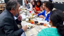 MS TU PAN Multigenerational family sitting in discussion during meal at table in restaurant Stock Footage