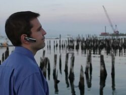 MS Man talking on bluetooth nearby ocean / Portland, ME, United States Stock Footage