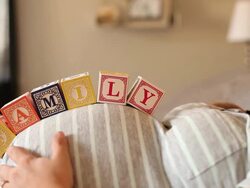 A pregnant women using blocks to spell the word FAMILY on her stomach. Stock Footage
