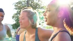 MS Friends laughing together after morning run in downtown neighborhood Stock Footage