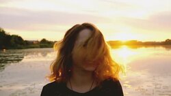 Woman on the background of the lake Stock Footage