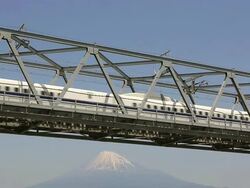 MS Shot of Bullet train Shinkansen passing on bridge in front of snow capped Mount Fuji / Fujigawa, Shizuoka Prefecture, Japan  Stock Footage