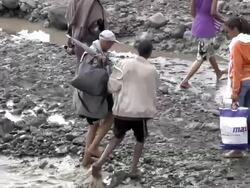 Men crossing river following bridge collapse Stock Footage