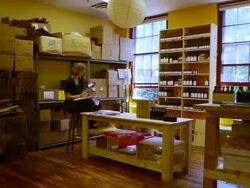 WS PAN Woman in shop taking inventory of her products / Burlington, Vermont, USA Stock Footage