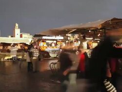 MS T/L Stormy skies over Djemaa el-Fna square and people eating food at stall / Marrakech, Morocco Stock Footage