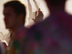 crowd of people at a Hindu festival throwing colored powder into the air and dancing Stock Footage