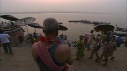 Umbrellas shade visitors at the Ganges River ghat in India. Stock Footage
