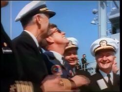 1960s John Kennedy + naval officers looking up smiling / watching missile / crossed fingers in foreground Stock Footage