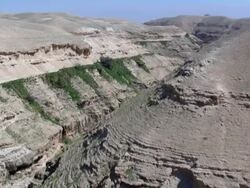  WS AERIAL PAN View of  wadi desert / Qumran,  Norrn Judea Desert, Israel Stock Footage