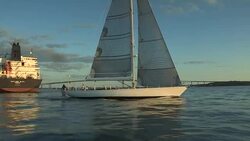 The large sailing yacht Heroina passes a container ship on Narragansett Bay. Stock Footage