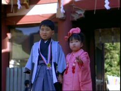 MCU 2 children, boy and girl, in traditional costume, looking to camera, laughing, Shichi-go-san children's festival, Akasaka, Tokyo, Japan Stock Footage