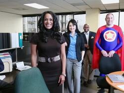 MS PAN Four business people and man dressing as superhero in blue outfit and red cape smiling  towards / Seattle, Washington, United States  Stock Footage