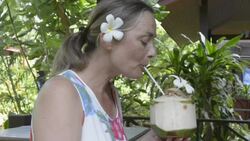 Woman drinking fresh coconut milk Stock Footage