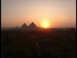 WA 3 pyramids silhouetted at sunset against desert, Egypt Stock Footage