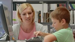 DS Woman and boy browsing on computer in library Stock Footage