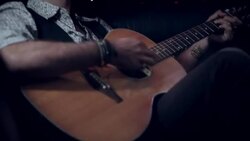 Rockstar plays acoustic guitar in limousine at awards show Stock Footage