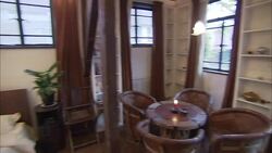 A candle burns on a table near a bed at a No. 9 Hotel penthouse in Shanghai, China. Stock Footage