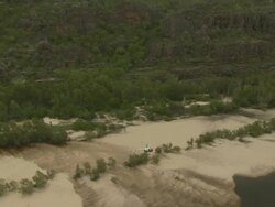 Robinson R22 helicopter flying over East Alligator River, Kakadu National Park, Australia Stock Footage