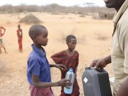 Young boy has his water bottled filled Stock Footage