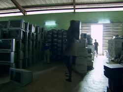 WS View of interior of truck people stacking old television and computer screens / Lagos, Nigeria Stock Footage