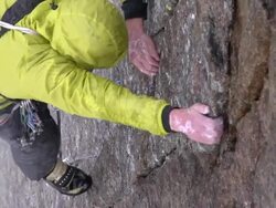 MS ZI Shot of male climber climbing wet rock with man below holding rope / Estes Park, Colorado, United States Stock Footage