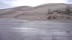 Woman hikes stormy Great Sand Dunes National Park Colorado Stock Footage