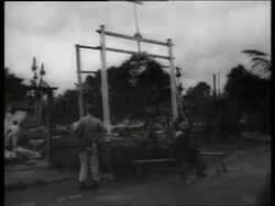 B/W 1960's soldiers stand and sit in destroyed village / Vietnam / SOUND Stock Footage