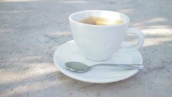 Cup of fresh coffee on a cafe table outdoors Stock Footage