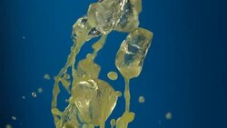 Beverage splash on blue background Stock Footage