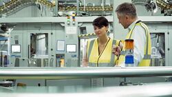 Workers talking on production line in printing plant Stock Footage