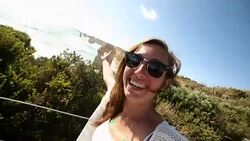 Young woman takes selfie portrait by the Twelve Apostles Stock Footage