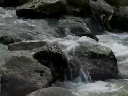 Close up water flowing over rocks and boulders in a small mountain stream, Brecon Beacons, Wales Stock Footage