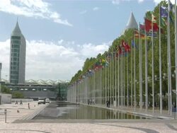 WS View of Expo with artificial lake and country flags / Lisbon, Portugal Stock Footage