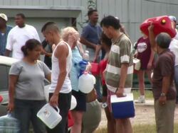 MS Shot of people holding gas cans and waiting in line for fuel as Hurricane Rita approaching Texas. Stock Footage
