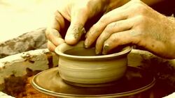 man creates pottery on a potter's wheel Stock Footage