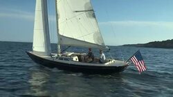 Two teenage boys sail a Morris M29 daysailer over Narragansett Bay, Rhode Island. Stock Footage