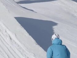 A skier doing a jumping trick on skis in the winter at a ski resort. - Slow Motion Stock Footage