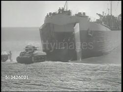 1940s: UNITED STATES NAVY:  WS (POV top of cargo ship) Approaching beach for landing. VS Male signaling w/ hands, M4 Sherman tanks & trucks rolling out of cargo ship onto beach, crowded landing on beach. WWII, World War II, Pacific Front Instructional Video