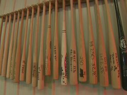 Medium pan-left pan-right - Baseball bat prototypes hang on a wall /  Indiana, United States Stock Footage