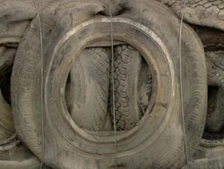 MS PAN Mountain of dirty wheels Stock Footage