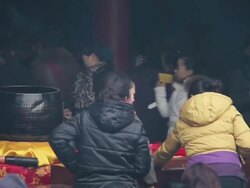 MS Pilgrims pray for good luck and put money into donation box during Chinese Lunar New Year at Taoist temple / xi'an, shaanxi, china Stock Footage
