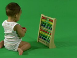 Baby playing with abacus, on green background Stock Footage