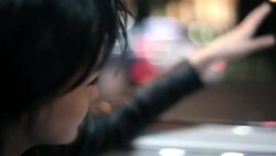 young woman riding in classic convertible floats her hand on the wind and waves at passing cars Stock Footage