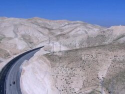 Aerial Highway 1 connecting Jerusalem and the West Bank until the Beit HaArava Junction with Route 90 south of Jericho near the shores of the Dead Sea. Northern Judea Desert Stock Footage